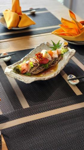 a plate of food with sushi on a table at Imperial Lexis Kuala Lumpur in Kuala Lumpur