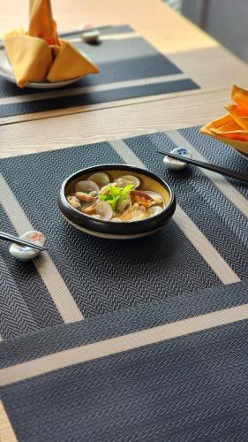 a bowl of food on top of a table at Imperial Lexis Kuala Lumpur in Kuala Lumpur