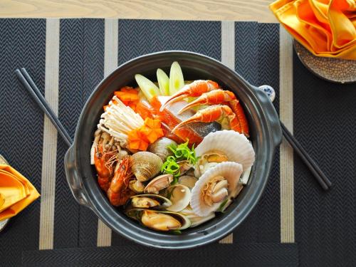 a pot filled with seafood and vegetables on a table at Imperial Lexis Kuala Lumpur in Kuala Lumpur