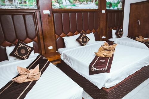 a bedroom with two beds with bows at Vientiane Garden Villa Hotel And Coffee in Vientiane