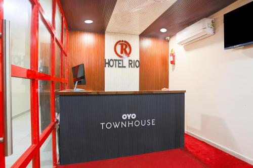 a reception desk in a room with a television at Townhouse RIO in Hyderabad