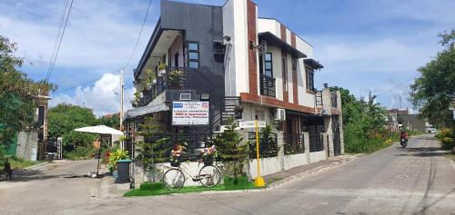 a building with a bike parked in front of it at Lucena Meg's Studio Apmnt Deluxe rm-Near SM-Wifi in Lucena