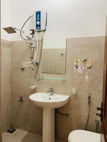 a bathroom with a sink and a mirror at Kandula Holiday Resort in Anuradhapura