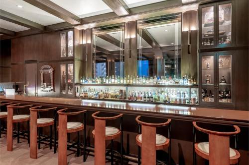 a bar with a row of stools in a room at ANA Crowne Plaza Kobe by IHG in Kobe