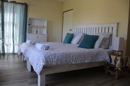 a bedroom with a large bed with towels on it at Ungabona in East London