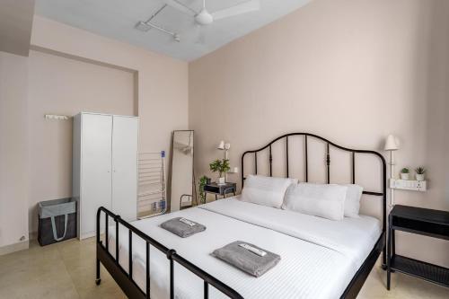 a bedroom with a large bed with two towels on it at Quirky 1BHK Bandra W by The Bombay Home Company in Mumbai