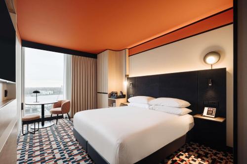 a hotel room with a large bed and a desk at DoubleTree by Hilton Amsterdam Centraal Station in Amsterdam