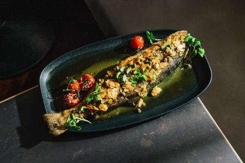 a black plate of food on a table at Hilton Vienna Plaza in Vienna