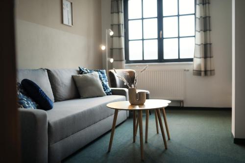 a living room with a couch and a table at Červený Mlýn in Tišnov