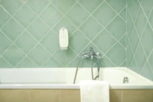 a bathroom with a bath tub with a soap dispenser at Červený Mlýn in Tišnov