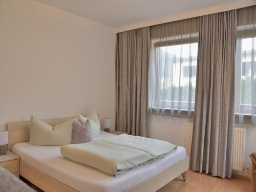 a bedroom with a white bed and a window at Chalet in Fulpmes near Stubai Glacier Skiing in Fulpmes