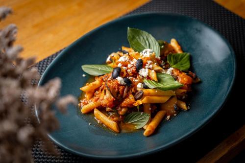 a blue plate of food on a table at Malabar Pool Villa Phuket in Phuket Town