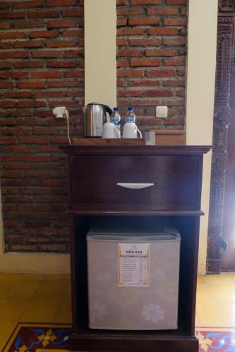 a wooden table with a box under it at Bale Devata Resort in Sleman
