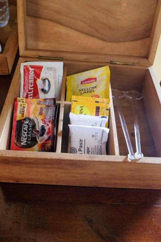 a drawer with food and other items in it at Bale Devata Resort in Sleman