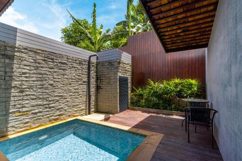 a swimming pool in the backyard of a house at Malabar Pool Villa Phuket in Phuket Town
