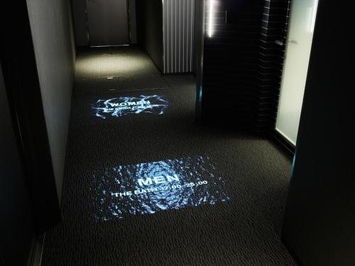 a dark room with a sign on the floor at sequence KYOTO GOJO in Kyoto