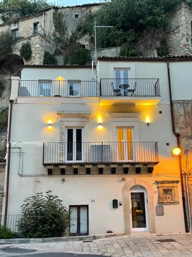 a white building with a balcony on top of it at Moronero in Ragusa
