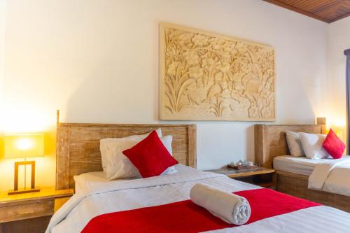 a bedroom with two beds and a painting on the wall at Villa Danu Kintamani in Kintamani