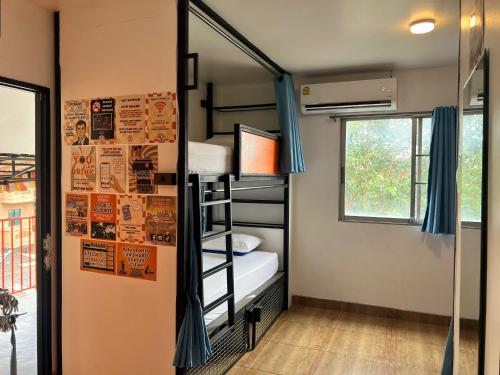 a room with a bunk bed and a window at Revolution Chiang Mai - Old Town in Chiang Mai