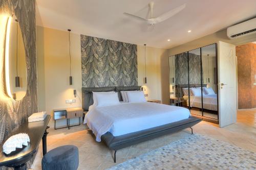 a bedroom with a large bed and a large mirror at Kobe Suite Resort in Watamu