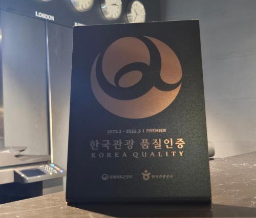 a sign that is on a table with clocks at Rivertain Hotel Gyeongju in Gyeongju