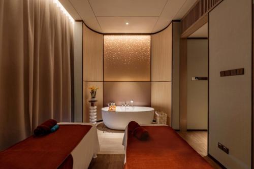 a bathroom with a bath tub and a sink at Imperial Lexis Kuala Lumpur in Kuala Lumpur