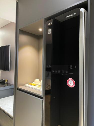 a refrigerator with its door open in a room at Rivertain Hotel Gyeongju in Gyeongju