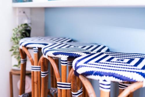 a group of stools with blue and white stripes at Sasta Nambucca in Nambucca Heads