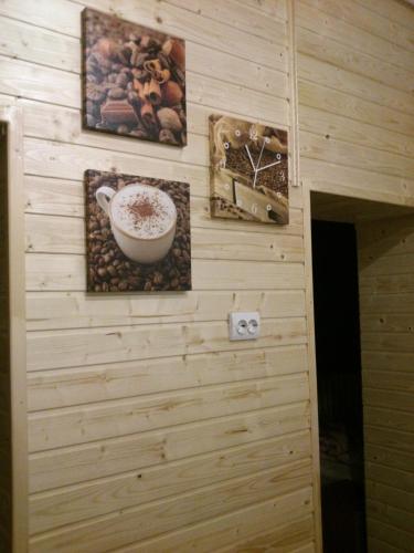 a wall with paintings and a bowl of coffee on it at Villa Svalyavа in Svalyava