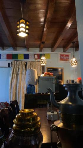 a room with a table and some lights on the ceiling at Hotel The Royal Mustang in Muktināth