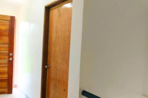 a wooden door in a room with a hallway at Ormoc City Gate 3 in Ormoc