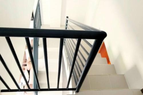 a staircase in a house with a person walking down it at Ormoc City Gate 3 in Ormoc