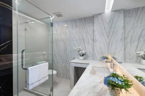a bathroom with a glass shower and a sink at 1BDR apartment with private terrace with jacuzzi and sea view by My Home Phuket in Ban Lum Fuang