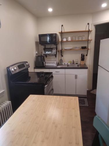 a kitchen with a stove and a counter top at Beautiful C&C in Elmont