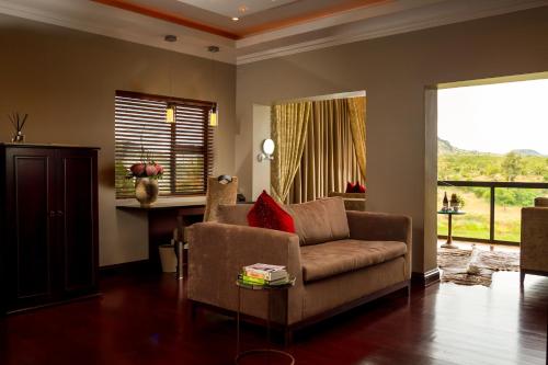 a living room with a couch and a table at Royal Mukumbura Malelane in Malelane