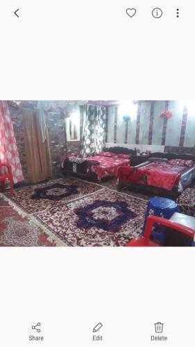 a living room with two beds in a room at Island homestay in dal lake in Srinagar