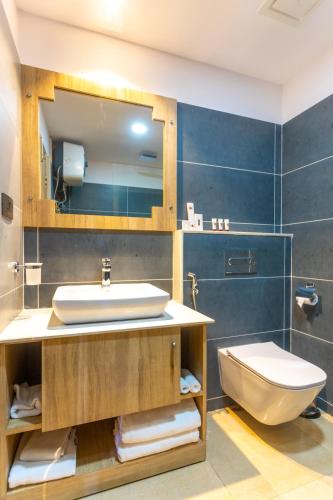 a bathroom with a sink and a toilet at Dreamland Gold Resort & Hotel in Bhairāhawā