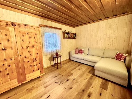 a living room with a couch and a window at Ferienhaus - Senn-Inn im Zentrum von Schladming in Schladming