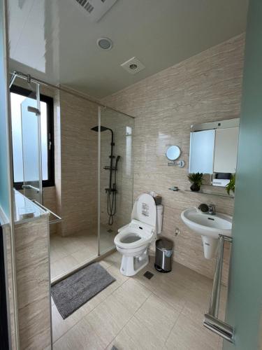 a bathroom with a toilet and a sink and a shower at Lucky House Homestay in Guilin