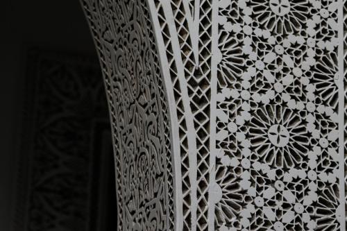 a white curtain with a flower pattern on it at Boutique Hotel Riad Almoulouk in Marrakech