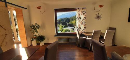 a dining room with a table and a window at Haus Sieben - Singer Lydia in Kötschach