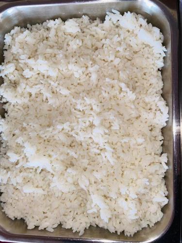 a tray filled with rice in a pan at MOUCECORE in Kigali