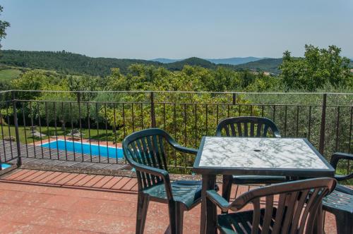 a patio with a table and chairs and a pool at Sant'Antonio in Volterra