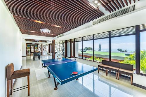 a ping pong table in a room with windows at Vietsovpetro Ho Tram Beach Resort & Spa in Ho Tram