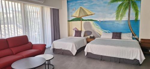 a hotel room with two beds and a couch at Love in the Gulf in Checheng