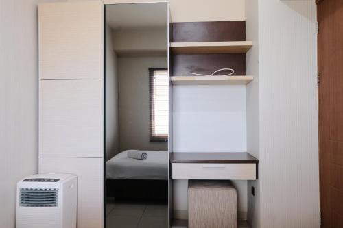 a room with a mirror and a bedroom with a bed at Spacious 3BR Combined Unit at Pinewood Apartment By Travelio in Sumedang