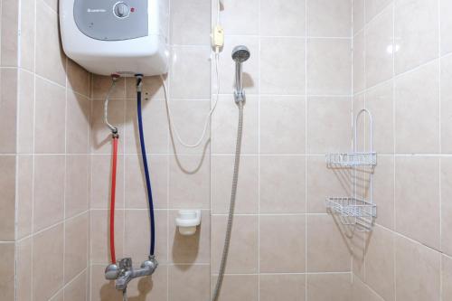 a bathroom with a shower with a toilet in it at Spacious 3BR Combined Unit at Pinewood Apartment By Travelio in Sumedang