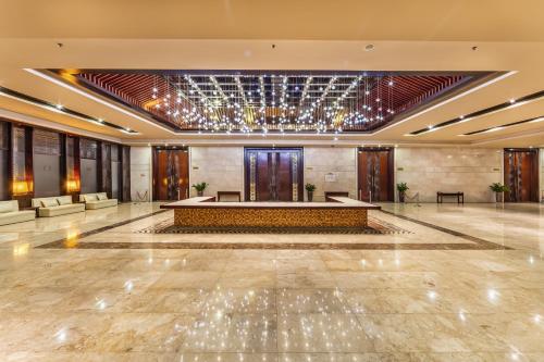 a large lobby with a table in the middle at Vietsovpetro Ho Tram Beach Resort & Spa in Ho Tram