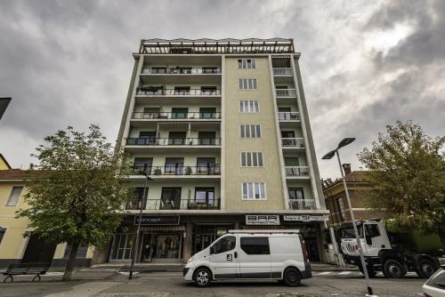 a white van parked in front of a tall building at Happy Venaria by Rentbeat in Venaria Reale