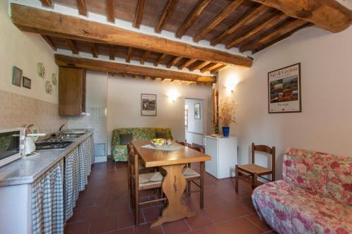 a kitchen and living room with a table and chairs at Sant'Antonio in Volterra
